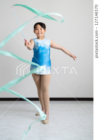 A lively girl trying gymnastics 127146570