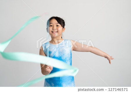 A lively girl trying gymnastics 127146571