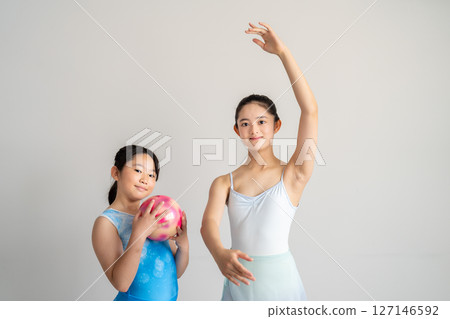 Two women dancing ballet and rhythmic gymnastics 127146592