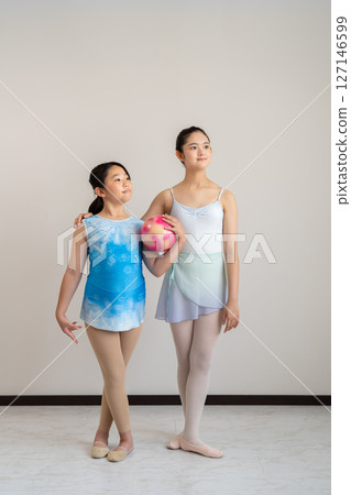 Two women dancing ballet and rhythmic gymnastics 127146599