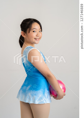 A lively girl trying gymnastics 127146889