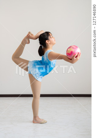 A lively girl trying gymnastics 127146890