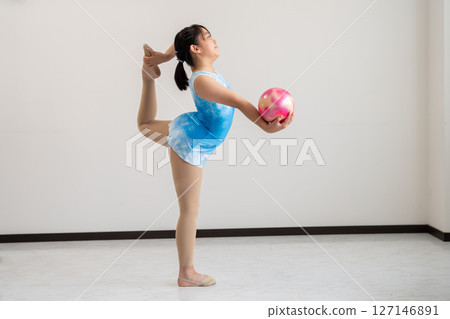 A lively girl trying gymnastics 127146891
