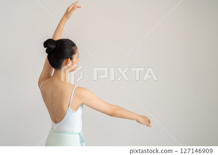 Back view of a young woman in ballet class Back view of a young woman in ballet class 127146909