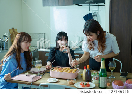 Women enjoying a home party 127146916