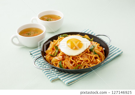 Western-style lunch of spaghetti Napolitana topped with fried egg and soup Western-style lunch of spaghetti Napolitana topped with fried egg and soup 127146925