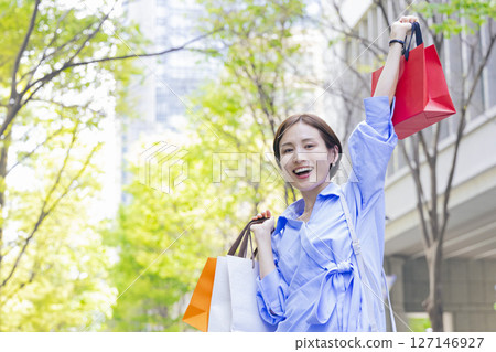 Shopping Woman holding a shopping bag Shopping Woman holding a shopping bag 127146927