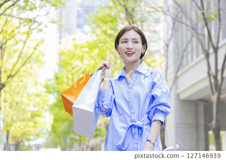 Shopping Woman holding a shopping bag 127146939