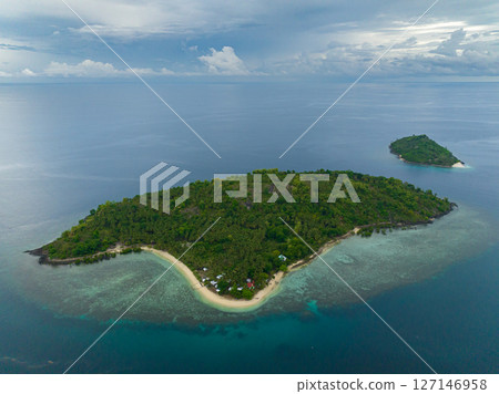 Topical Island with sandy beach under blue sky and clouds. Buh-Buh Island in Zamboanga, Philippines. Topical Island with sandy beach under blue sky and clouds. Buh-Buh Island in Zamboanga, Philippines. 127146958