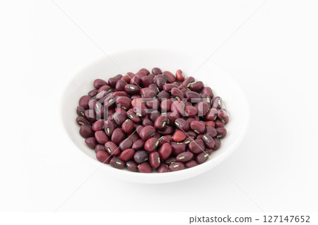 Black peas in a plate on a white background Black peas in a plate on a white background 127147652