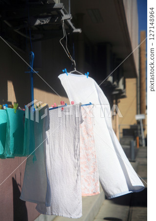 Laundry blowing in the wind 127148964