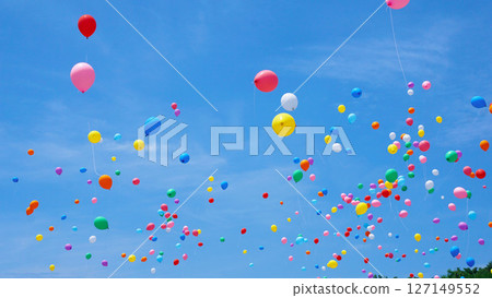 Many colorful balloons flying in the blue sky 127149552
