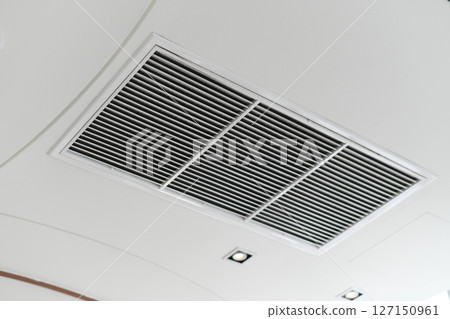 Clean modern interior showing ceiling air vent grille. hvac air conditioner ventilation duct system provides comfortable cooling for healthy indoor air quality and climate control 127150961