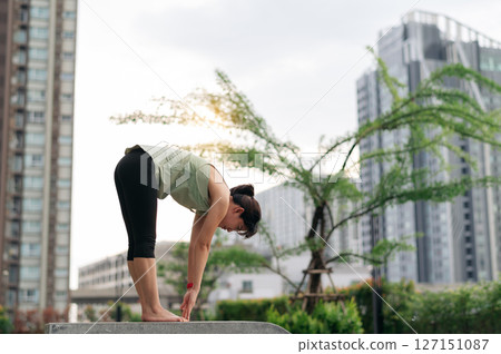 Urban city sunset fitness for asian woman. yoga workout with stretching exercise reduces medical injury risk like shoulder pain muscle strain or inflammation for total wellness healthcare Urban city sunset fitness for asian woman. yoga workout with stretching exercise reduces medical injury risk like shoulder pain muscle strain or inflammation for total wellness healthcare 127151087