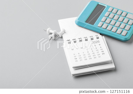 2026 Calendar with blue calculator and pins, tax payment, financial planning 127151116