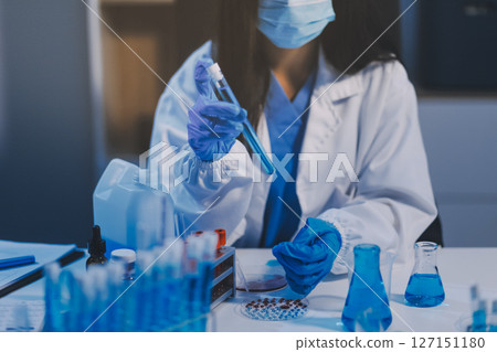 Research, experiment and medical trial being done by a scientist in a lab, science facility or hospital. One young, serious and professional researcher organizing, sorting or making a discovery 127151180