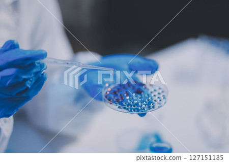 Research, experiment and medical trial being done by a scientist in a lab, science facility or hospital. One young, serious and professional researcher organizing, sorting or making a discovery 127151185