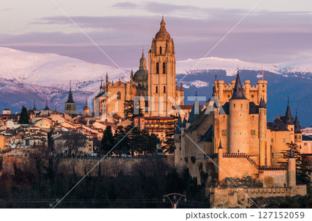 Segovia Alcazar and Cathedral stand majestically against the snowy Guadarrama mountains. 127152059