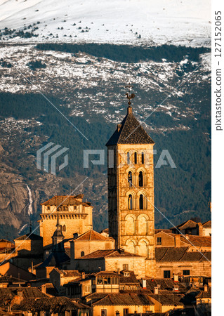 Segovia cityscape, with the iconic tower rising against the snowy Guadarrama mountains. 127152065