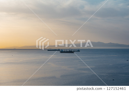 Sunset Over the Strait of Gibraltar with Cargo Ships and Iberian Peninsula View from Ceuta, Spain Sunset Over the Strait of Gibraltar with Cargo Ships and Iberian Peninsula View from Ceuta, Spain 127152461