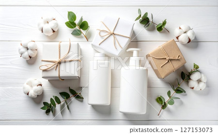 The design presents a cosmetic cream product decorated with green leaves on a white background. The design presents a cosmetic cream product decorated with green leaves on a white background. 127153073