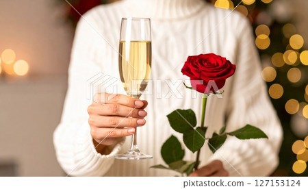 Celebratory champagne glasses and red roses for a romantic toast Celebratory champagne glasses and red roses for a romantic toast 127153124