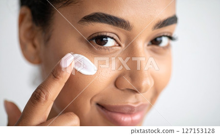 Young woman's natural beauty routine includes applying mascara to her clean eyelashes for a cosmetic facial treatment 127153128