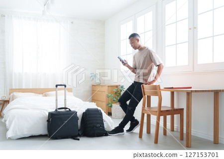 Foreign tourists using smartphones at a hotel 127153701