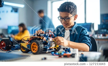 Workers working on computers in a car repair industry workshop 127153843