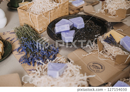 Lavender soaps displayed with dried flowers and kraft packaging in a calming workspace. Lavender soap, self-care trends, calming rituals, wellness lifestyle 127154030