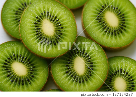 Juicy Green Kiwi Fruit Slices Arranged in a Patterned Overlap, Macro Shot with Fresh Texture 127154287