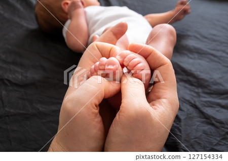 Tender Moment: Holding Newborn Baby Feet 127154334