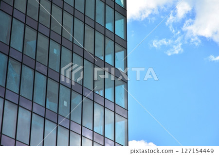 Modern sustainable glass office buildings. Exterior view of corporate headquarters glass buildings architecture.Glass windows in energy-efficient buildings. Financial business center buildings.  127154449