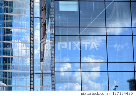 Modern sustainable glass office buildings. Exterior view of corporate headquarters glass buildings architecture.Glass windows in energy-efficient buildings. Financial business center buildings.  127154450