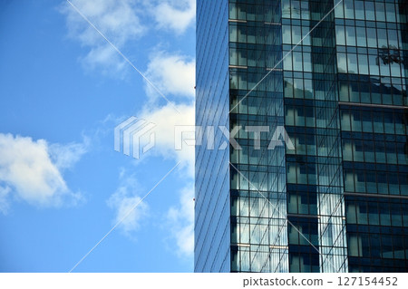 Modern sustainable glass office buildings. Exterior view of corporate headquarters glass buildings architecture.Glass windows in energy-efficient buildings. Financial business center buildings.  127154452