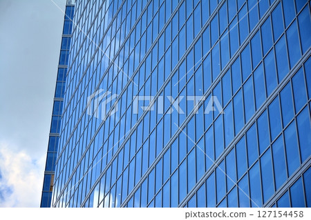 Modern sustainable glass office buildings. Exterior view of corporate headquarters glass buildings architecture.Glass windows in energy-efficient buildings. Financial business center buildings.  127154458