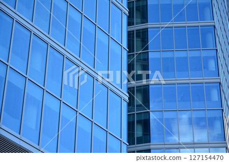 Modern sustainable glass office buildings. Exterior view of corporate headquarters glass buildings architecture.Glass windows in energy-efficient buildings. Financial business center buildings. Modern sustainable glass office buildings. Exterior view of corporate headquarters glass buildings architecture.Glass windows in energy-efficient buildings. Financial business center buildings. 127154470