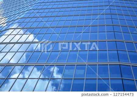 Modern sustainable glass office buildings. Exterior view of corporate headquarters glass buildings architecture.Glass windows in energy-efficient buildings. Financial business center buildings.  127154473