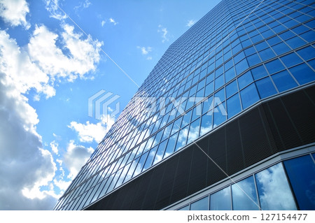 Modern sustainable glass office buildings. Exterior view of corporate headquarters glass buildings architecture.Glass windows in energy-efficient buildings. Financial business center buildings.  127154477