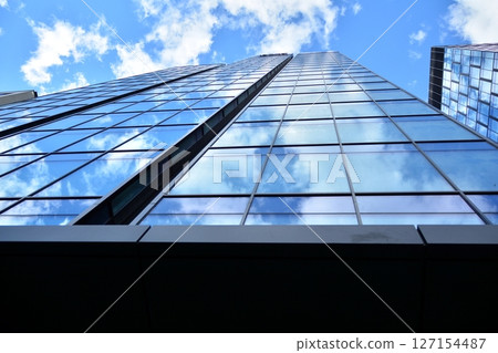 Modern sustainable glass office buildings. Exterior view of corporate headquarters glass buildings architecture.Glass windows in energy-efficient buildings. Financial business center buildings. Modern sustainable glass office buildings. Exterior view of corporate headquarters glass buildings architecture.Glass windows in energy-efficient buildings. Financial business center buildings. 127154487