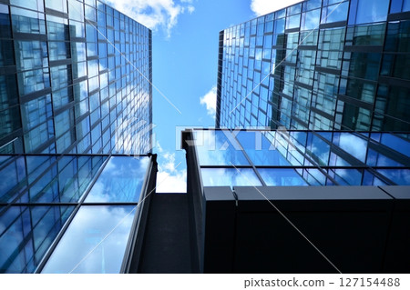 Modern sustainable glass office buildings. Exterior view of corporate headquarters glass buildings architecture.Glass windows in energy-efficient buildings. Financial business center buildings. Modern sustainable glass office buildings. Exterior view of corporate headquarters glass buildings architecture.Glass windows in energy-efficient buildings. Financial business center buildings. 127154488