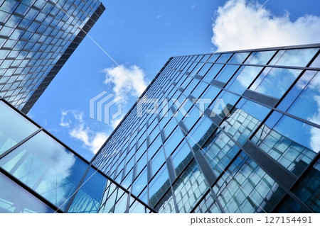 Modern sustainable glass office buildings. Exterior view of corporate headquarters glass buildings architecture.Glass windows in energy-efficient buildings. Financial business center buildings.  127154491