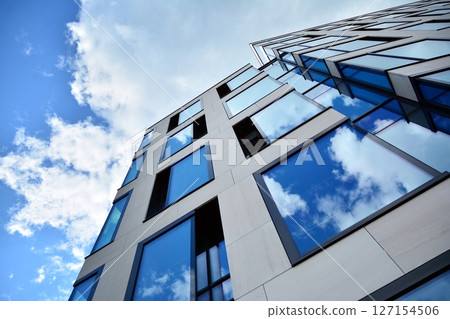 Modern sustainable glass office buildings. Exterior view of corporate headquarters glass buildings architecture.Glass windows in energy-efficient buildings. Financial business center buildings.  127154506