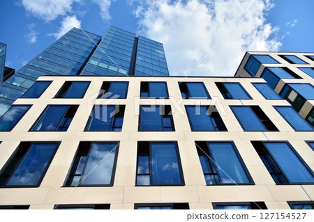 Modern sustainable glass office buildings. Exterior view of corporate headquarters glass buildings architecture.Glass windows in energy-efficient buildings. Financial business center buildings. Modern sustainable glass office buildings. Exterior view of corporate headquarters glass buildings architecture.Glass windows in energy-efficient buildings. Financial business center buildings. 127154527