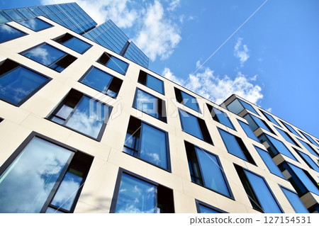 Modern sustainable glass office buildings. Exterior view of corporate headquarters glass buildings architecture.Glass windows in energy-efficient buildings. Financial business center buildings.  127154531