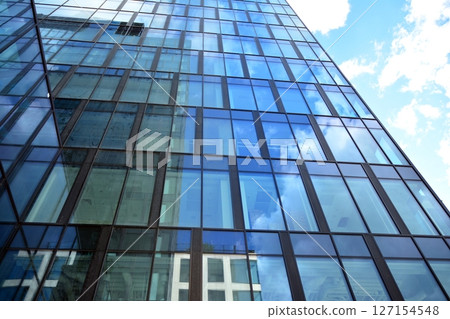 Modern sustainable glass office buildings. Exterior view of corporate headquarters glass buildings architecture.Glass windows in energy-efficient buildings. Financial business center buildings. Modern sustainable glass office buildings. Exterior view of corporate headquarters glass buildings architecture.Glass windows in energy-efficient buildings. Financial business center buildings. 127154548
