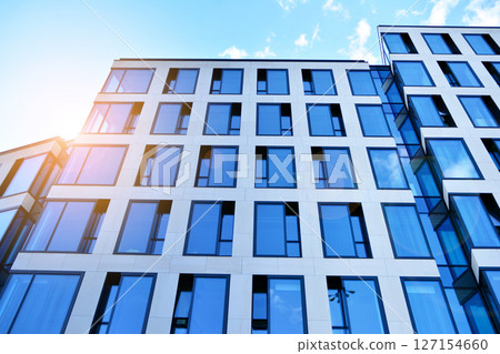 Modern sustainable glass office buildings. Exterior view of corporate headquarters glass buildings architecture.Glass windows in energy-efficient buildings. Financial business center buildings. Modern sustainable glass office buildings. Exterior view of corporate headquarters glass buildings architecture.Glass windows in energy-efficient buildings. Financial business center buildings. 127154660