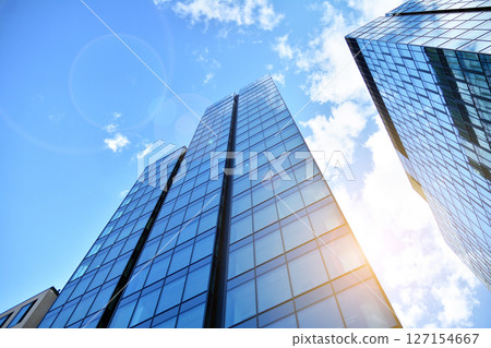 Modern sustainable glass office buildings. Exterior view of corporate headquarters glass buildings architecture.Glass windows in energy-efficient buildings. Financial business center buildings. Modern sustainable glass office buildings. Exterior view of corporate headquarters glass buildings architecture.Glass windows in energy-efficient buildings. Financial business center buildings. 127154667