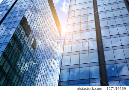 Modern sustainable glass office buildings. Exterior view of corporate headquarters glass buildings architecture.Glass windows in energy-efficient buildings. Financial business center buildings.  127154669