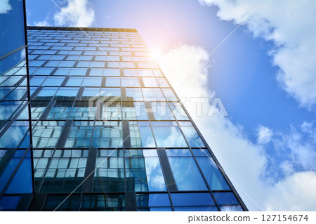 Modern sustainable glass office buildings. Exterior view of corporate headquarters glass buildings architecture.Glass windows in energy-efficient buildings. Financial business center buildings.  127154674